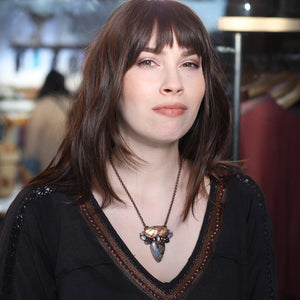 A woman modeling a fantasy style crystal necklace made with the electroforming technique