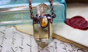 a fantasy style crystal necklace with citrine and golden rutile quartz
